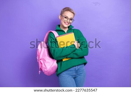 Photo of cute cheerful person beaming smile hands hold copybooks isolated on violet color background