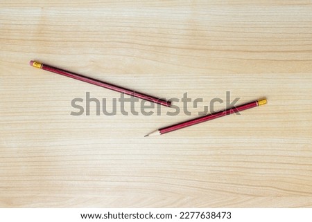 A photo of pencils isolated on wooden background, after some edits.