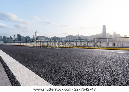 empty road wity city skyline in hong kong china