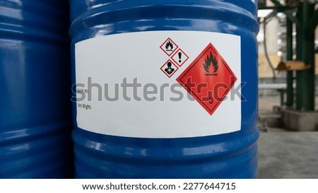 A chemical hazard warning label mounted on a 200 liter drum shows a level three red label indicating flammable liquids that can ignite. Royalty-Free Stock Photo #2277644715