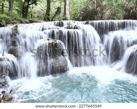 The Kuang Si Falls or Kuang Xi Falls, alternatively known as the Tat Kuang Si Waterfalls, is a three-tiered waterfall with emerald pools about 29 kilometers south of Luang Prabang
