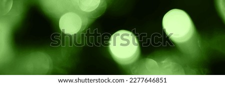 Blurred lights, green background, banner texture. Abstract bokeh with soft light header. Wide screen wallpaper. Panoramic web banner with copy space for design