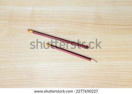 A photo of pencils isolated on wooden background, after some edits.