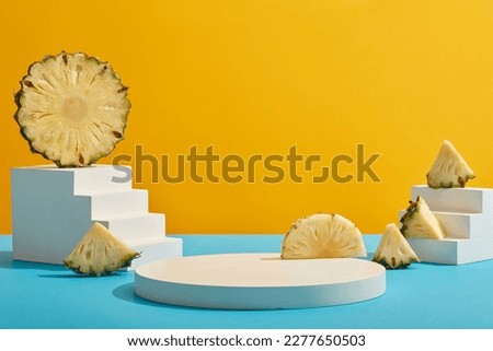Minimal empty display product presentation scene with white geometries podium and pineapple slices on yellow background. Pineapple rich in antioxidant vitamin C and slows down the aging process