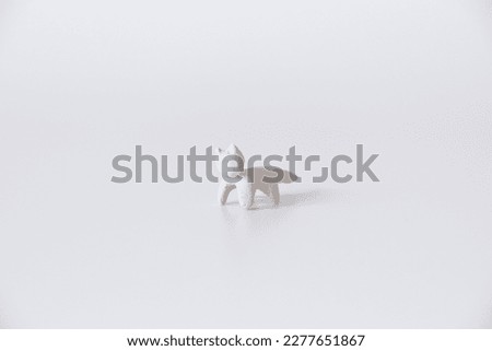 miniature clay cat on a white background close-up