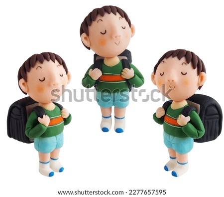A boy proudly carrying his school bag(This is a photo of a clay work)3 Patterns