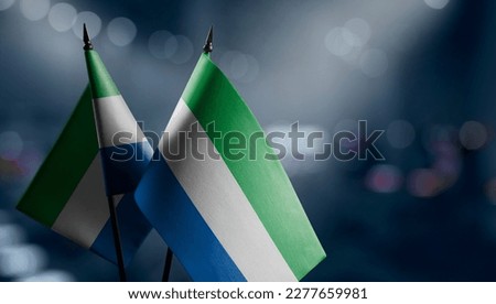Small flags of the Sierra Leone on an abstract blurry background. Royalty-Free Stock Photo #2277659981