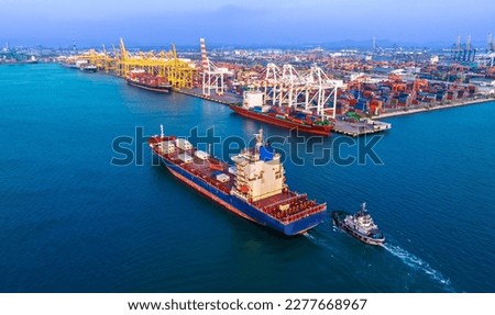 Large cargo ships are docked at a large export warehouse in an industrial zone. Royalty-Free Stock Photo #2277668967