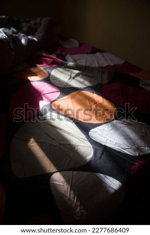 splash of sunlight on a colorful sleeping mattress
