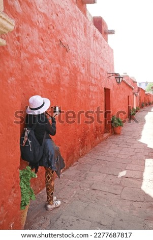 Female Visitor Photographing the Narrow Path in Monastery of Santa Catalina de Siena, Historical Centre of the City of Arequipa, Peru, South America