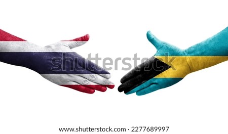 Handshake between Bahamas and Thailand flags painted on hands, isolated transparent image.