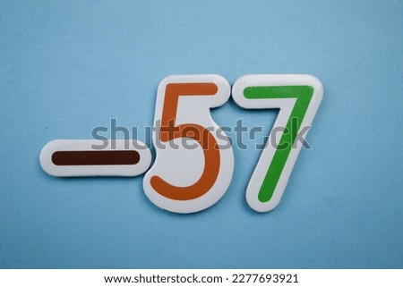 -57 is a colorful photo of -57, taken from above, over a blue background.