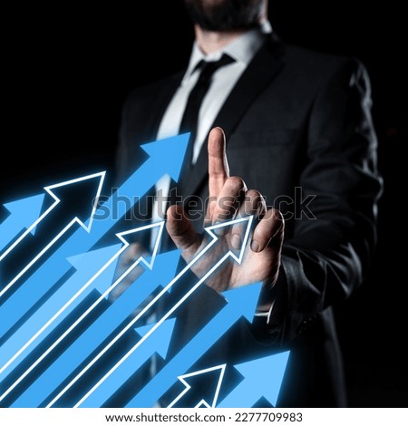 Businessman standing and pressing virtual button with his finger. Man in dark suit presents new technological system. Futuristic style image. Colored glow.