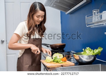 Asian woman making healthy food salad To take care health eat food that are beneficial to body Do it with cleanliness such as washing your hand before doing symptoms washing vegetables before eating