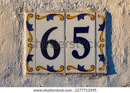 Old Weathered House Number 65, Tile on Wall
