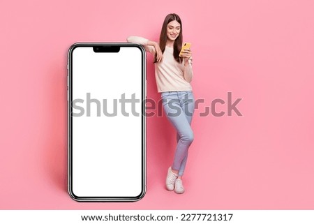 Full length body size view of beautiful trendy girl using device copy space isolated over pink pastel color background