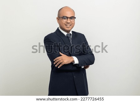 Portrait of Young asian businessman on isolated white background. Handsome middle aged Indian businessman in office uniform. Royalty-Free Stock Photo #2277726455