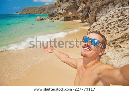 man making his selfie on a beach