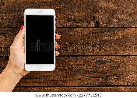 Female hands holding mobile phone with copyspace. Banner