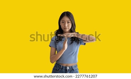 Woman makes a T hand sign indicating a request for a time-out or a temporary break, Made a serious tired face and asked to rest for a moment, Make a t-shaped symbol to show halftime and break time.