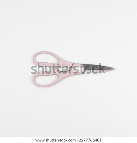 pink scissors on white background 