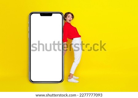 Full length photo of young attractive successful woman wear formal outfit hold paper banner advert excited new app advert isolated on bright yellow color background