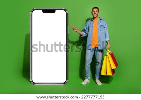 Full length photo of young guy recommend online shopping eshop big board phone isolated on green color background