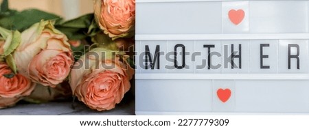Happy Mother's Day.Lightbox with the word Happy Mother's Day next to flowers. Holiday card.