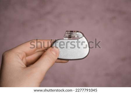 medical pacemaker hold in hand Royalty-Free Stock Photo #2277791045