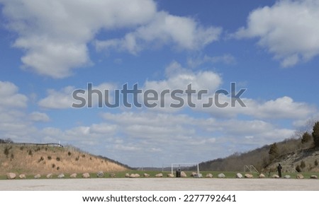 Beautiful wide-angle picture at local park on a beautiful day in the heartland of America recreation area with fluffy clouds land decoration rocks hills Landscape and outdoor photography.
