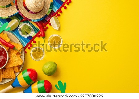 Cinco-de-mayo concept. Top view photo of traditional food nacho chips salsa sauce chilli tequila with salt lime sombrero serape cactus and maracas on isolated vivid yellow background with copyspace Royalty-Free Stock Photo #2277800229