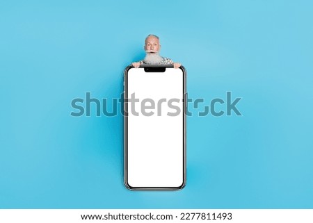 Full body photo of impressed aged person behind big empty space screen poster isolated on blue color background