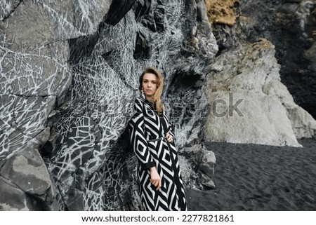stylish photo of a girl on a black beach in Iceland