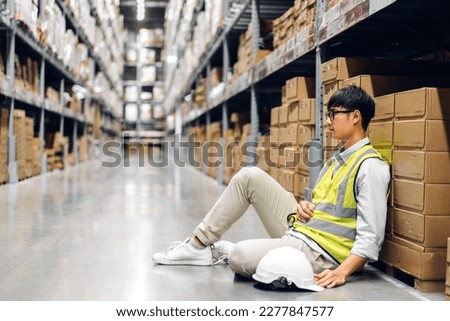 Portrait asian engineer man shipping order detail on clipboard check goods and supplies on shelves with goods background inventory in factory warehouse.logistic industry and business export