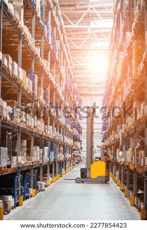 Modern warehouse interior with shelves and boxes and forklift loader Royalty-Free Stock Photo #2277854423