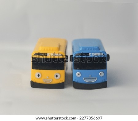 yellow and blue tayo bus car cartoon toy smiling