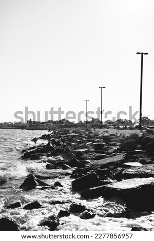 Beautiful and sharp black and white picture of little waves crushing on rocks 