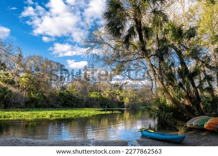 Canoes in lake surrounded by tropical trees at sunset in Wekiwa Springs State Park, Florida Royalty-Free Stock Photo #2277862563