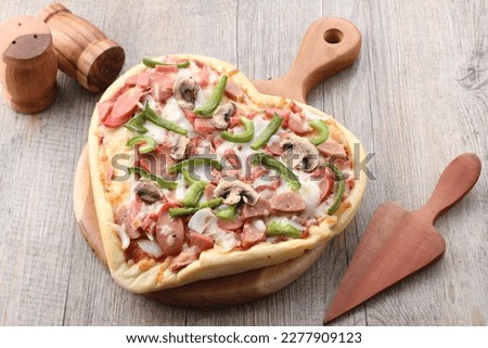 Pizza is a dish of Italian origin consisting of a usually round, flat base of leavened wheat-based dough topped with tomatoes, cheese, and often various other ingredients 