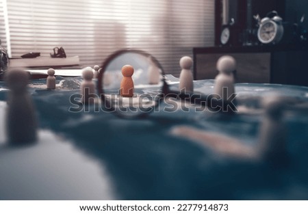 The wooden doll represents the employee of the company and magnifying glass view them represents the employee of the company on world map represents networking, connection. find new job. Royalty-Free Stock Photo #2277914873