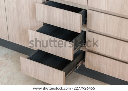 house boasts white cabinetry and drawers as part of its design interior. Royalty-Free Stock Photo #2277926455