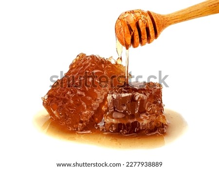 Fresh Honeycomb slice and wooden honey dipper isolated on white background 