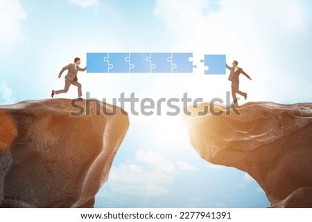 Concept of teamwork with bridge being built Royalty-Free Stock Photo #2277941391