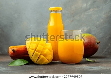 mango juice. Fresh tropical fruit smoothie on a dark background. Long banner format.