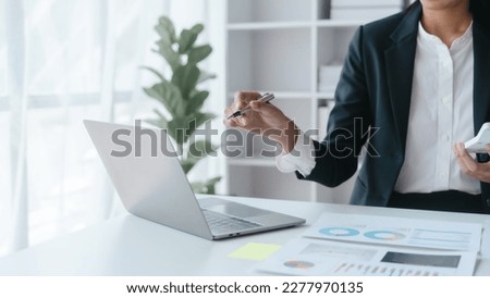 Laptop computer pc, Close up hands of asian bookkeeper female working with stack of papers and balance sheet with bureaucracy hardworking in office desk.
