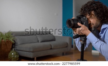 Real estate photographer taking pictures and videos  at house  in apartment living room with professional camera - selling home with real estate agency and home staging indoor home design 