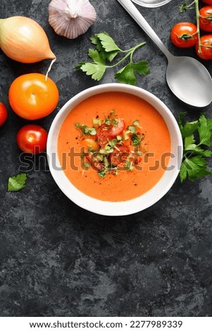 Gazpacho soup in bowl over dark stone background with free text space. Cold tomato soup. Top view, flat lay Royalty-Free Stock Photo #2277989339