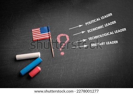 USA Leadership Concept. Flag and colored pieces of chalk on a dark blackboard.