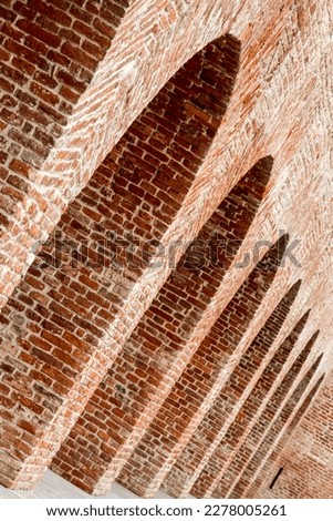 The arches of an old fortress wall. Dutch angle Royalty-Free Stock Photo #2278005261
