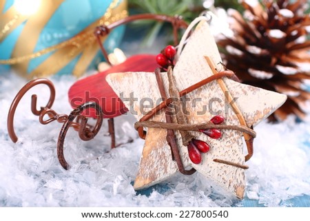 Christmas composition with wooden star and sleigh  on snow
